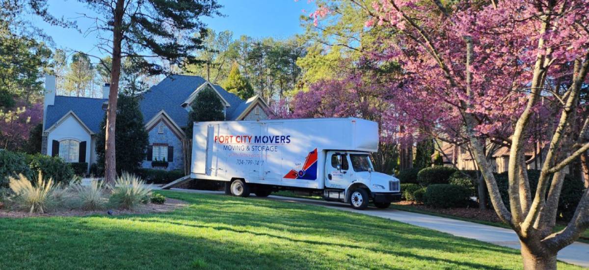 Port City Movers moving truck parked in residential driveway during move