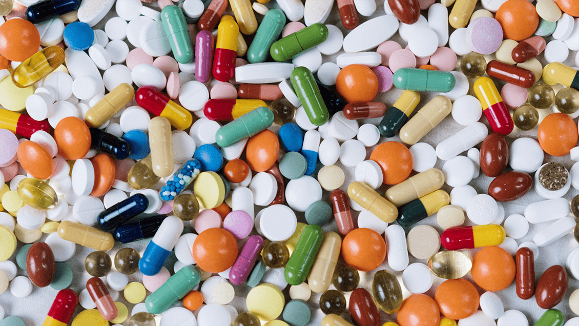 Medications pile expressing concept of solutions for non-opioid pain management