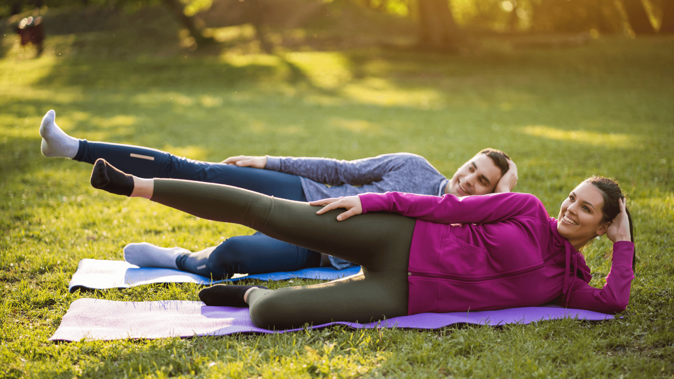 A man and a woman are doing exercises on yoga mats outdoors, symbolizing the importance of physical therapy and exercise in managing sciatica pain.