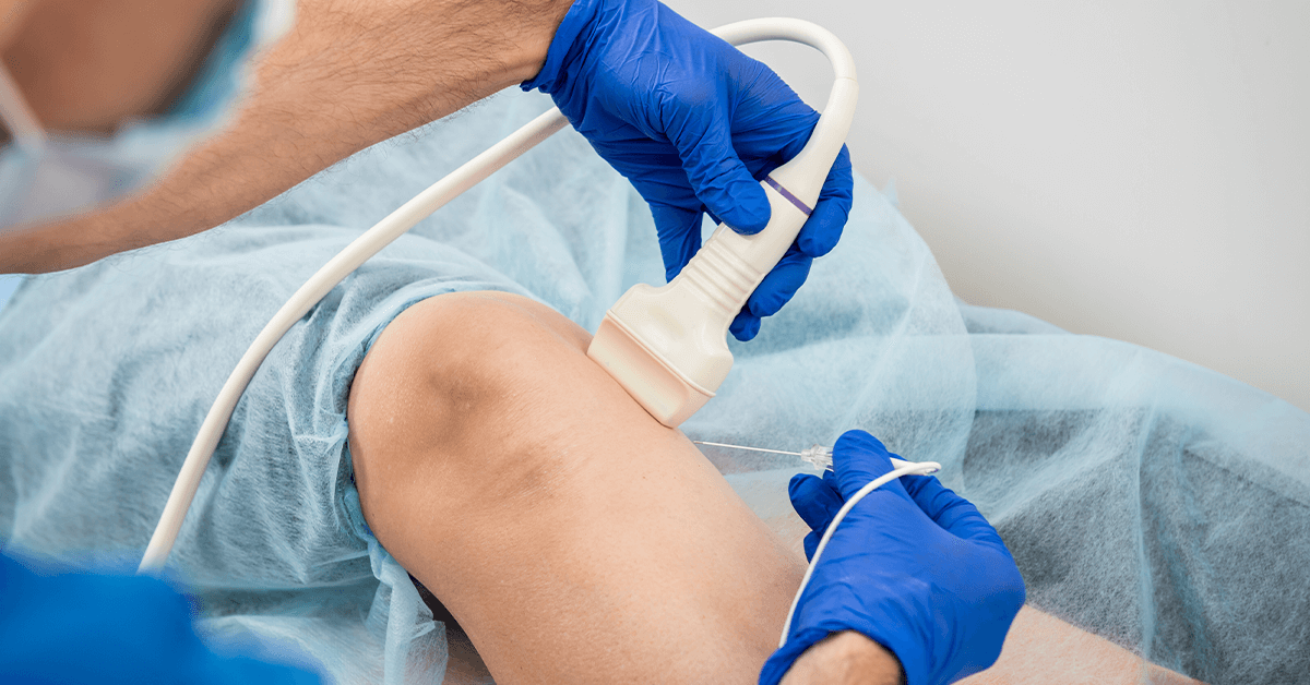 A doctor wearing blue surgical gloves performs an ultrasound-guided injection into a patient's knee, illustrating a minimally invasive, precision-based procedure for joint pain relief or regenerative medicine treatment.