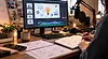 Explainer video workspace with animated icons on a monitor, a voiceover microphone, and storyboard sketches.