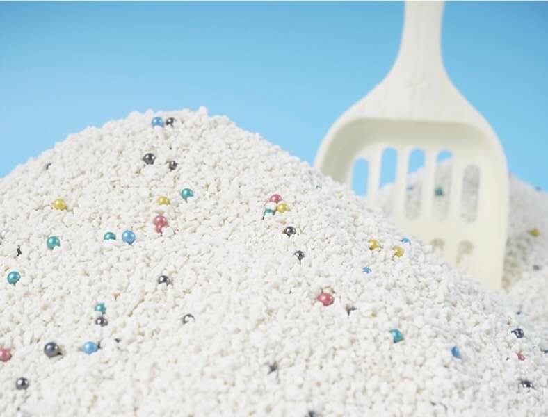 Cat litter with colorful beads, close-up shot.