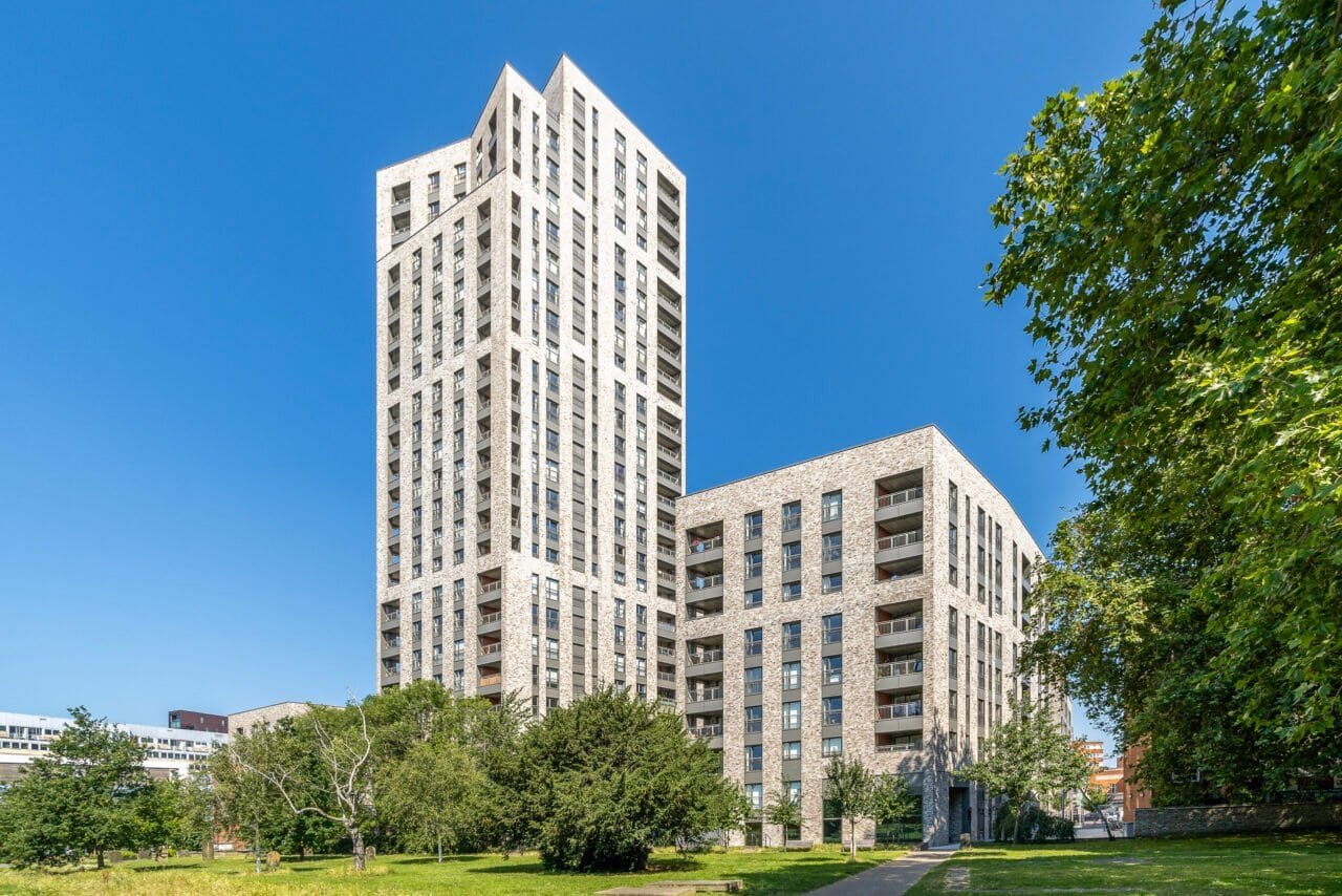 Modern high-rise residential buildings with green park area in London, UK.