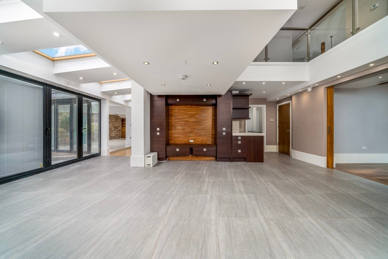 Modern open-plan living space with large windows and contemporary interior design.