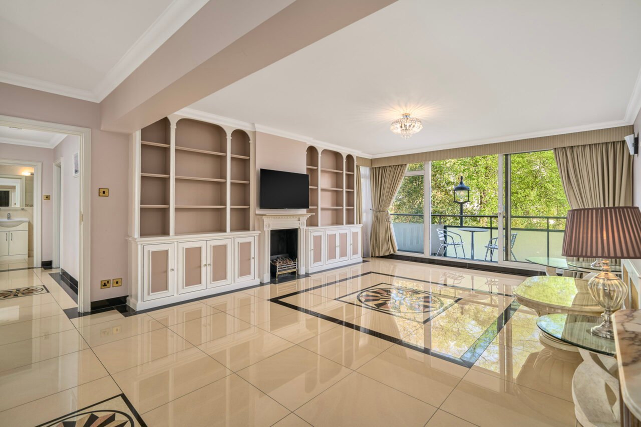 A spacious living room with large windows and elegant decor, bright and airy.