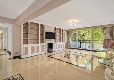 A spacious living room with large windows and elegant decor, bright and airy.