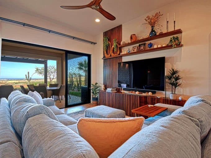 Luxurious Living Room With Ocean View At Quivira Los Cabos Real Estate, Featuring Modern Furniture, Stylish Decor, And Indoor-Outdoor Space For Relaxation And Entertainment.