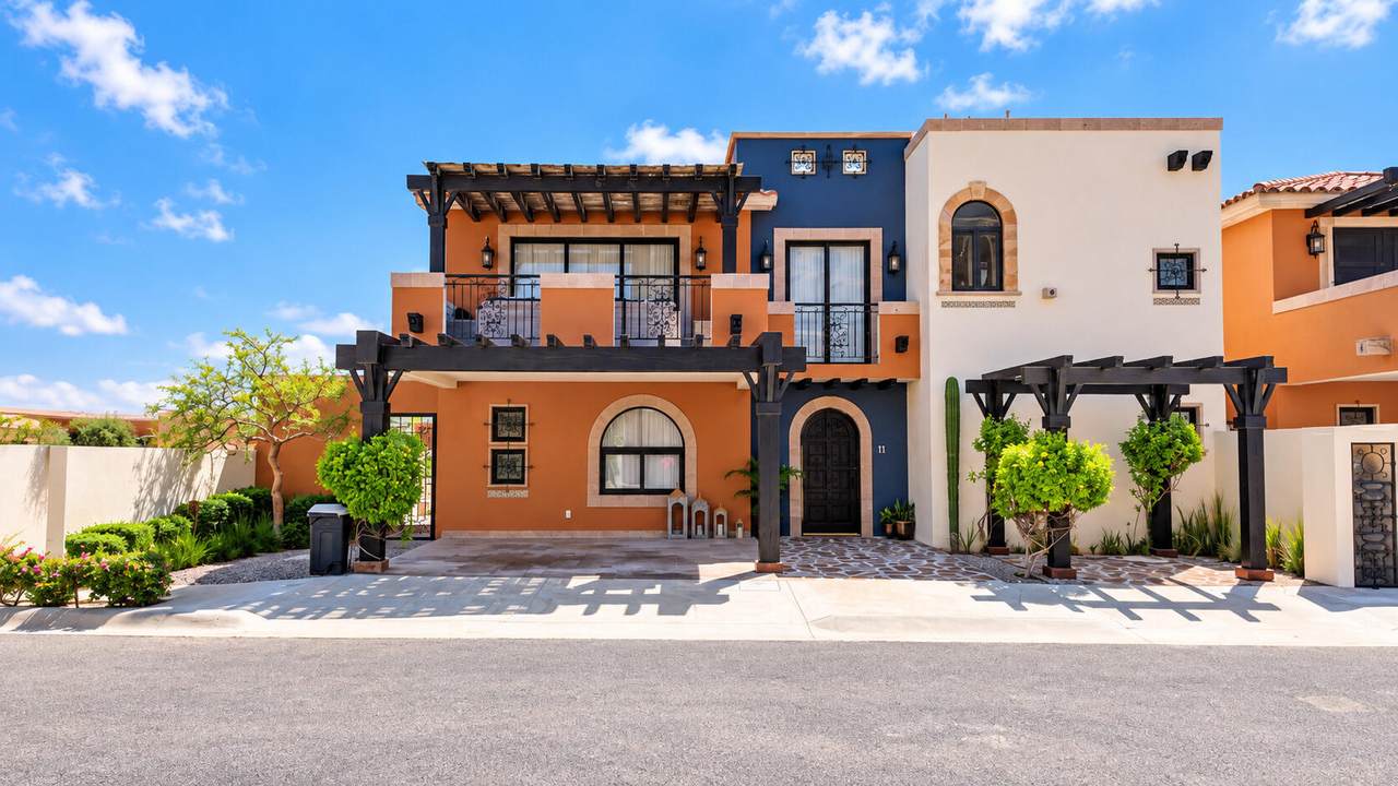 Quivira Los Cabos Luxury Villa With Vibrant Exterior And Lush Landscaping.