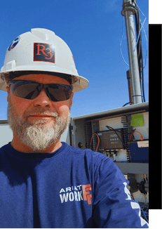 High-voltage utility worker operating advanced automation equipment outdoors.