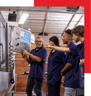 Advanced industrial automation training session with technicians and engineers operating control systems in a modern manufacturing facility.