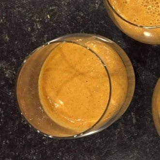 Refreshing golden turmeric beverage in a glass, healthy superfood drink.