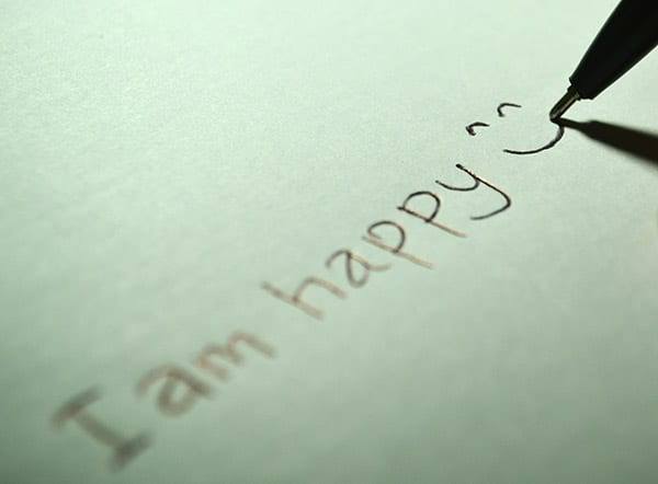 Tam happy written with a pen on paper.