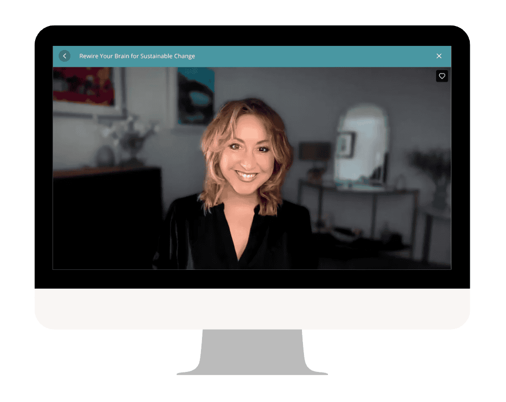 Woman smiling during online neuroplasticity course on computer screen.