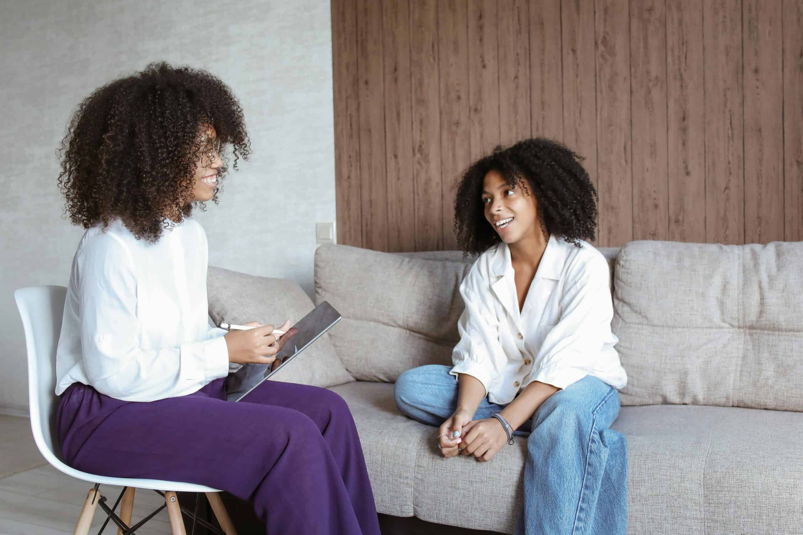 Therapist and client engaging in a counseling session in a comfortable, modern space.