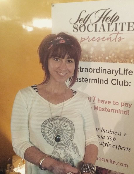 Woman smiling at Self Help Socialite event promoting personal growth.