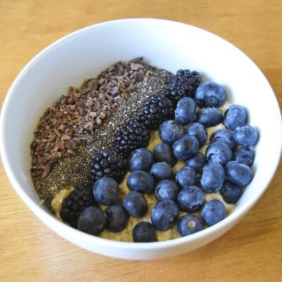 Blueberries with chia seeds and flaxseed in a white bowl for healthy eating.