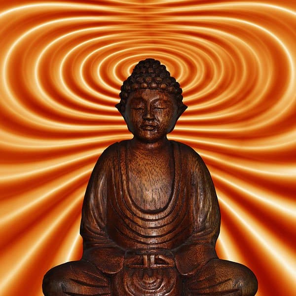 Wooden Buddha statue meditating with swirling orange background.