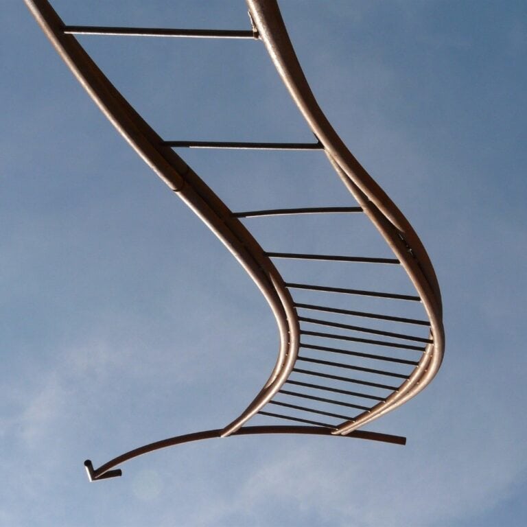 Artistic DNA strand sculpture against a blue sky at Raw Horizons.