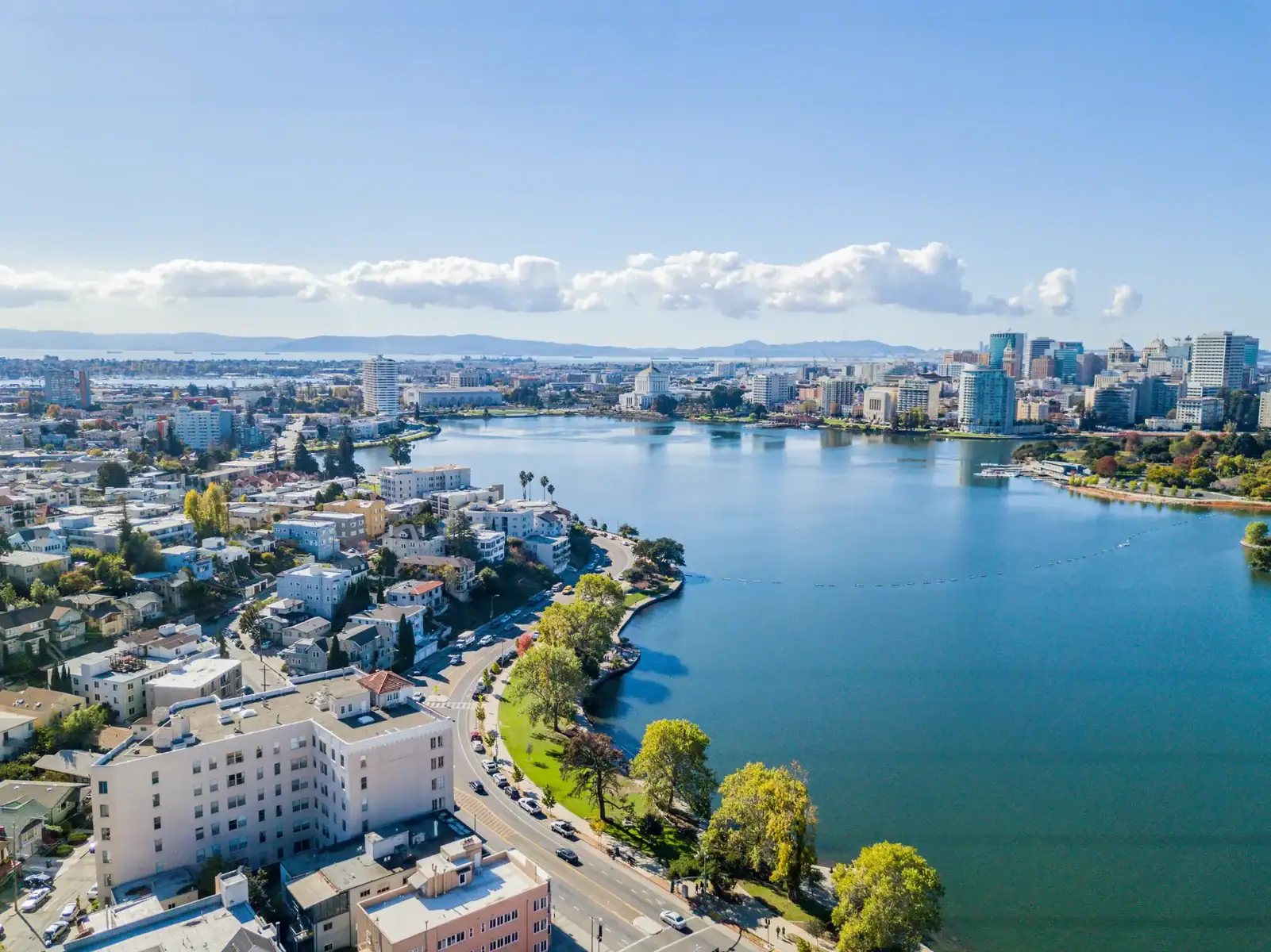 Aerial view of a city skyline with a river and lush green parks, showcasing urban development and sc.