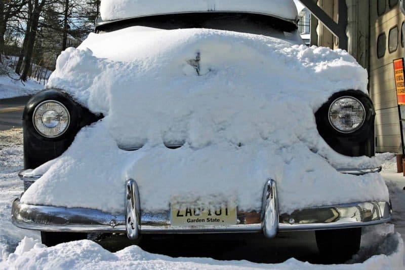 This is a picture of a classic car being stored in the winter