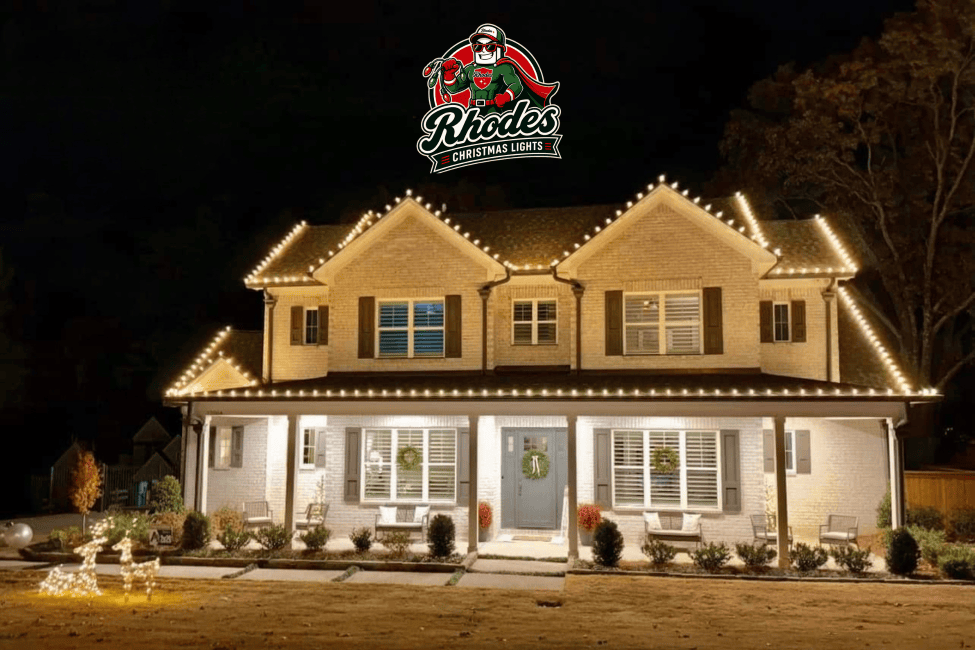 House decorated with Christmas lights and illuminated roofline at night.