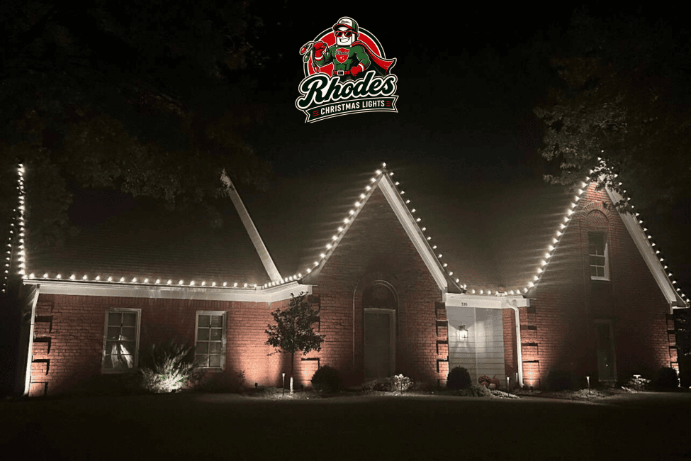 Brightly lit house with Christmas lights and Rhodes Christmas Lights logo.