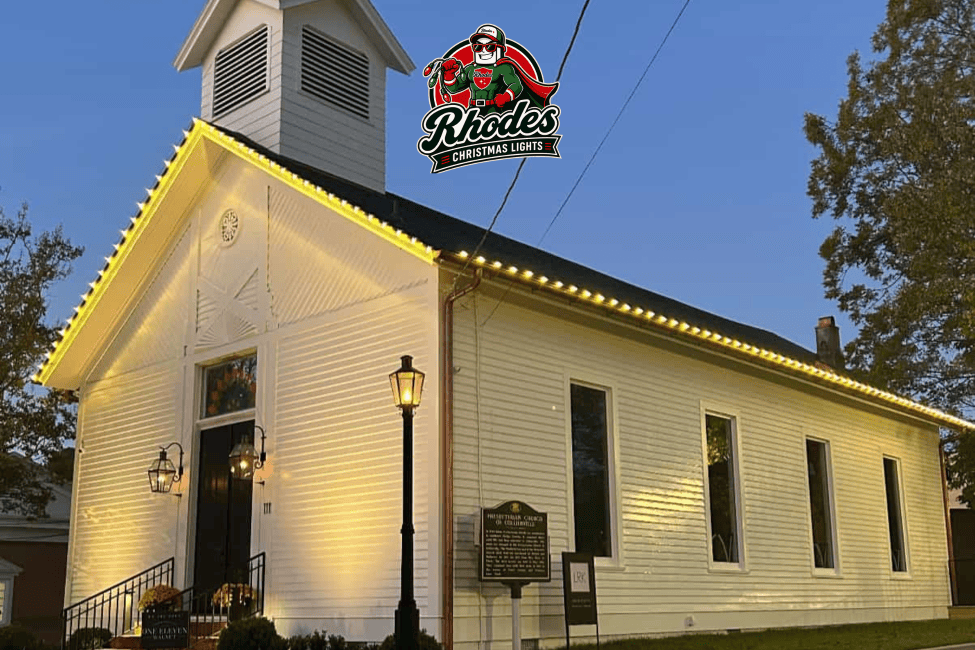Festive Christmas lights decorating Rhodes Church building at night.