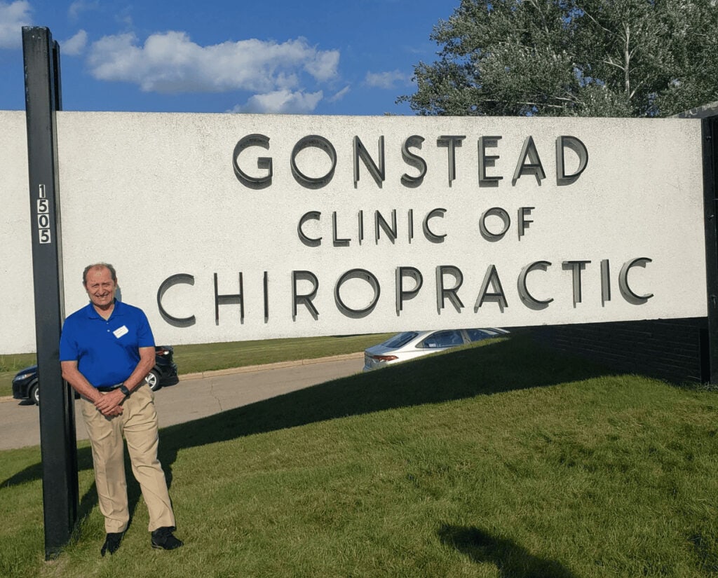 Chiropractor standing outside Dublin Gonstead Chiropractic Clinic in daytime.