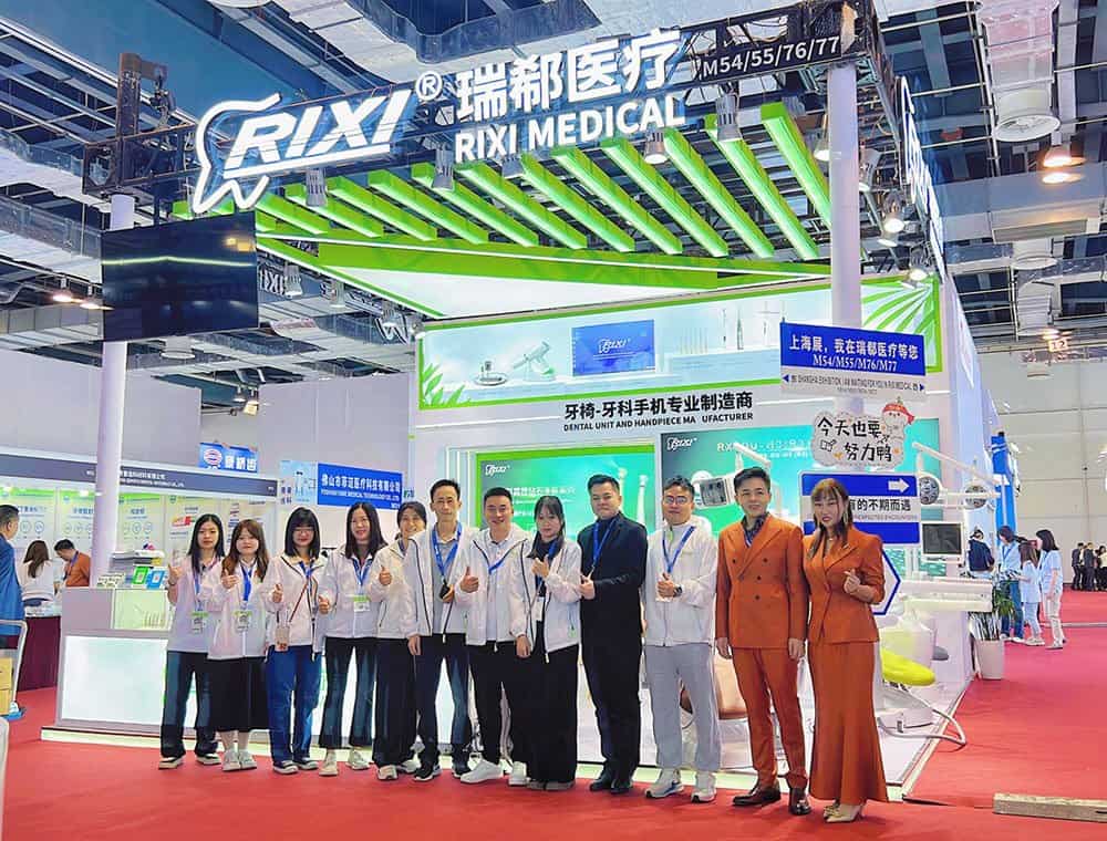 RIXI Medical team and visitors at a green dental equipment exhibition stand