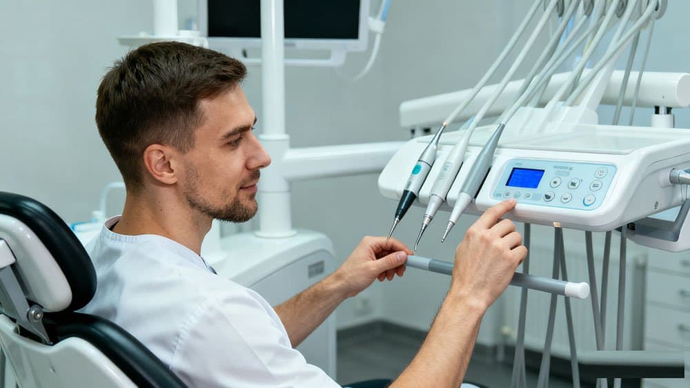 A dentist utilizing the integrated technology of a premium dental chair to streamline a procedure and improve workflow.