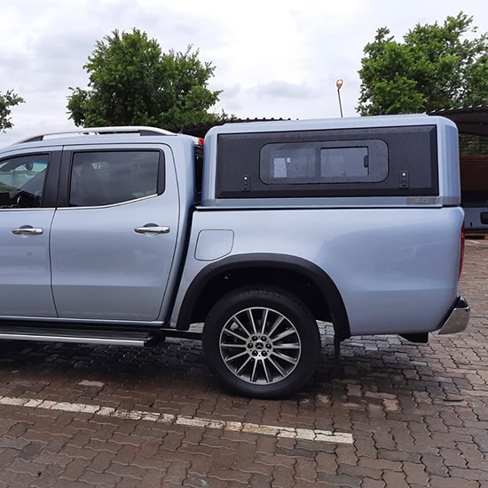 Durable stainless steel canopy installed on a pickup truck for secure storage and protection. Perfect for commercial and outdoor utility needs.