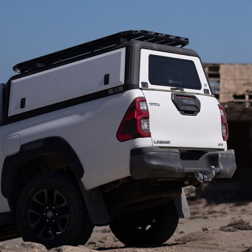 Rustic stainless steel canopy mounted on a pickup truck for durable outdoor protection and enhanced vehicle aesthetics.