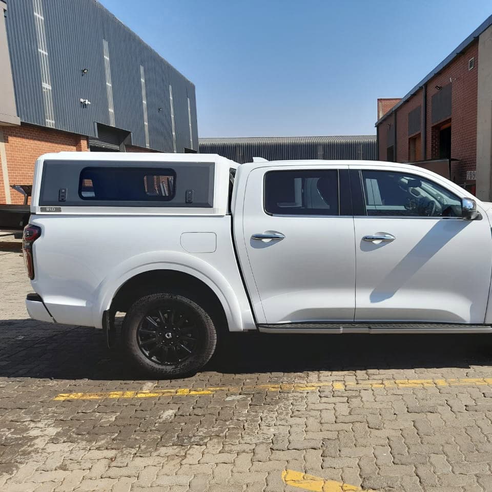 Stainless steel canopy custom-fitted for pickup trucks, providing enhanced protection and style.