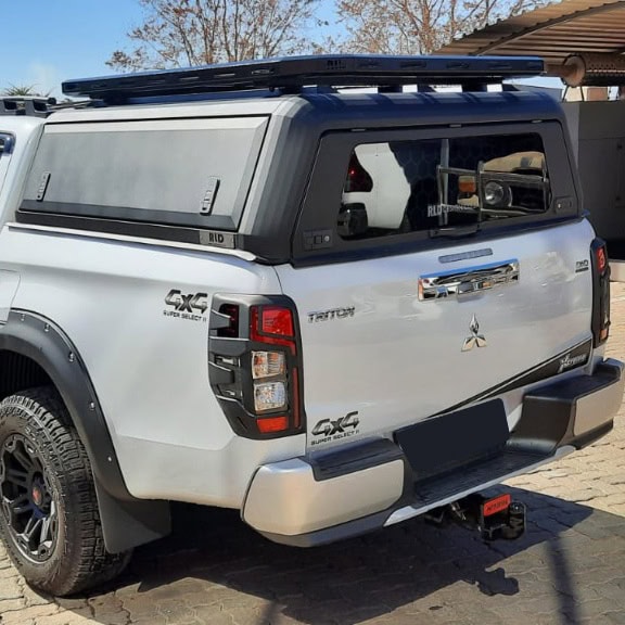 Stainless steel canopies installed on pickup trucks for enhanced durability and style.