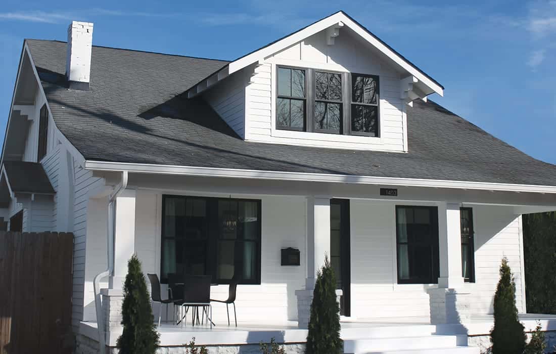 Exterior view of a well-maintained home showcasing roofing, siding, windows, and gutters