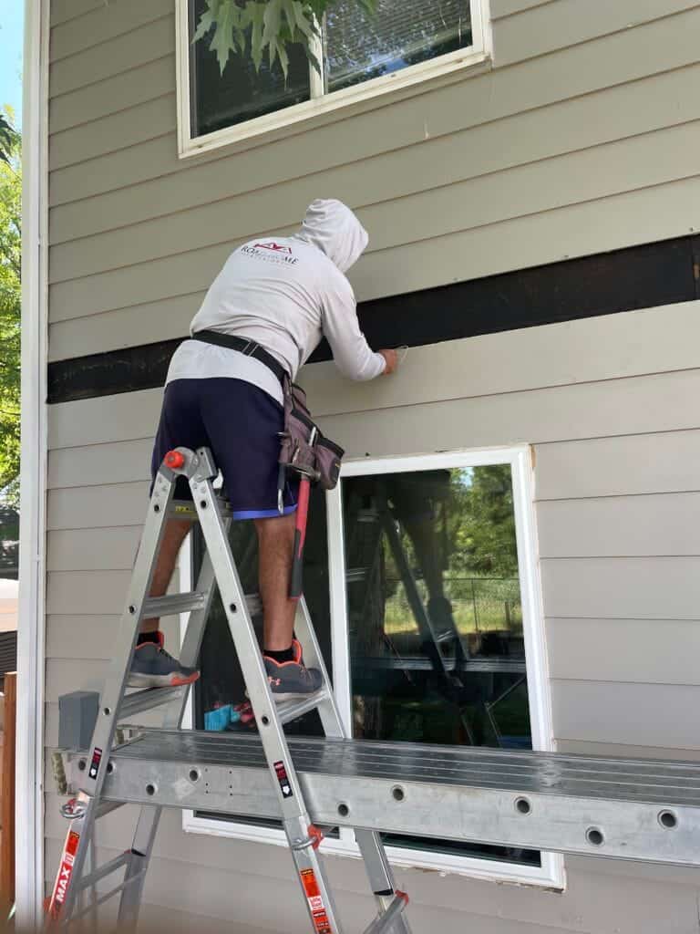 Crew performing siding and fascia repair on a home in Colorado