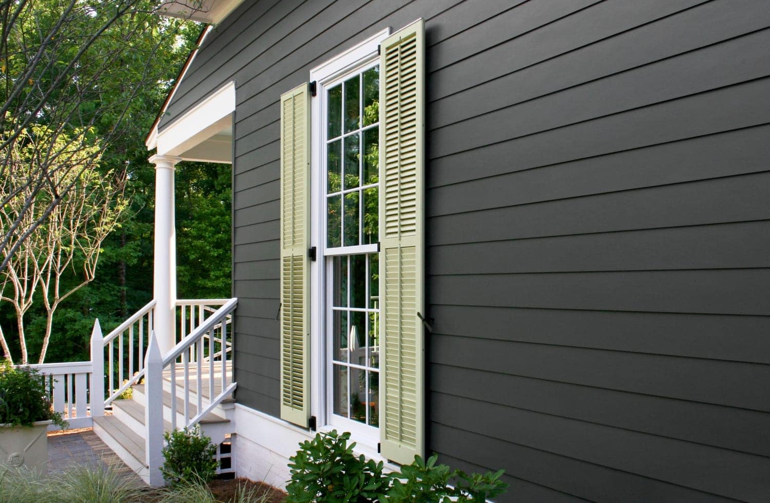 A side of a home featuring new James Hardie fiber cement siding with modern trim.