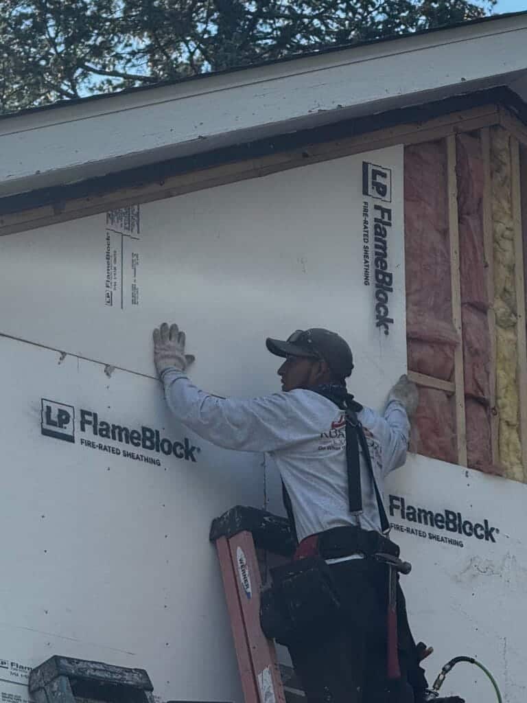 Road Home Exteriors siding crew installing LP FlameBlock fire-rated sheathing
