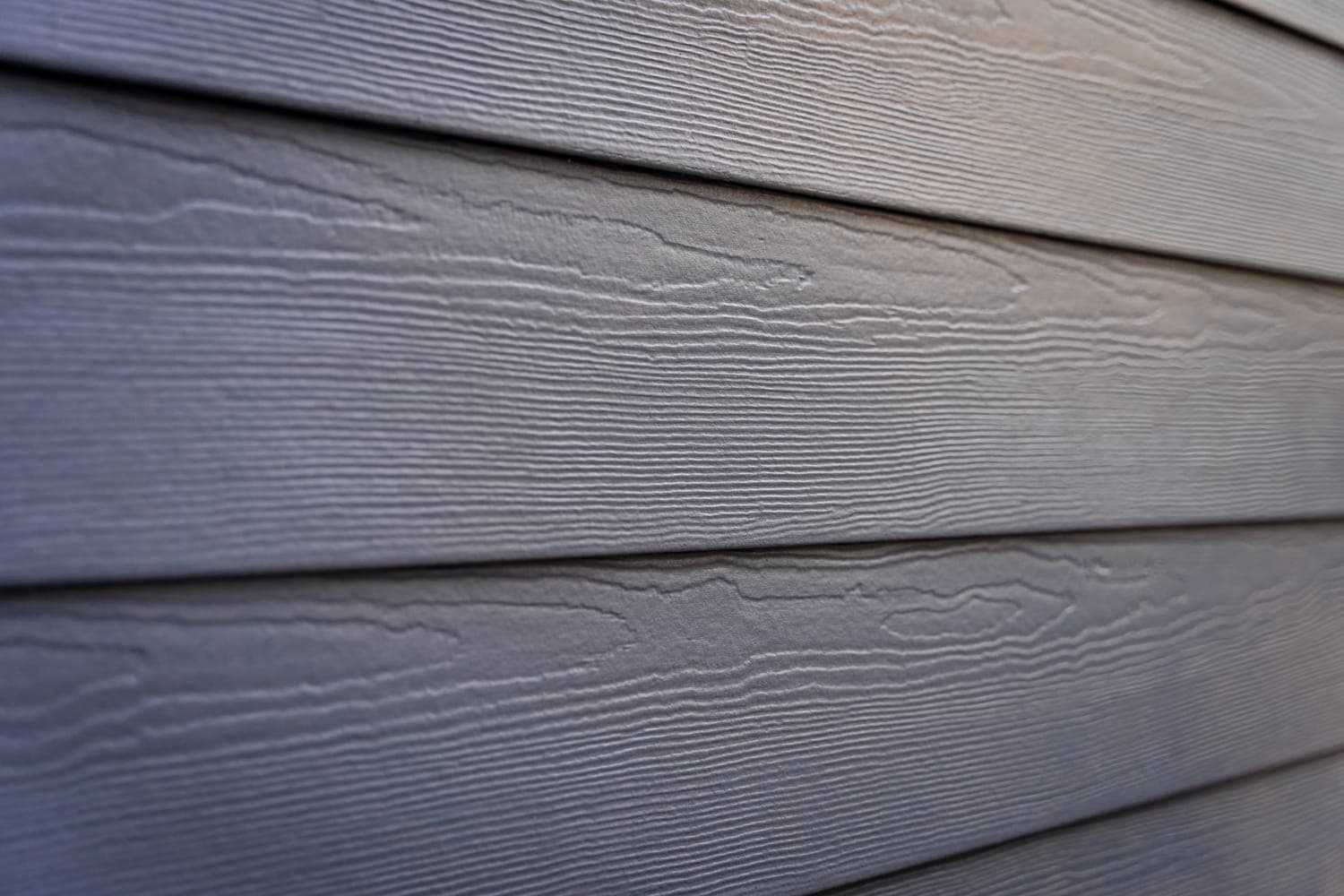 Close-up of non-combustible James Hardie lap siding texture, a Class A fire-rated building material.