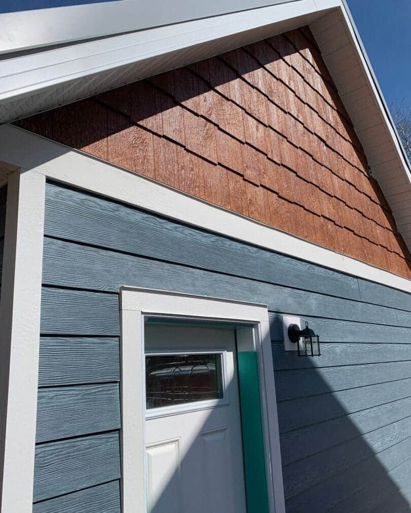 Residential exterior with Woodtone RusticSeries lap siding featuring a woodgrain finish installed on fiber cement or engineered wood siding in the Denver Metro region.