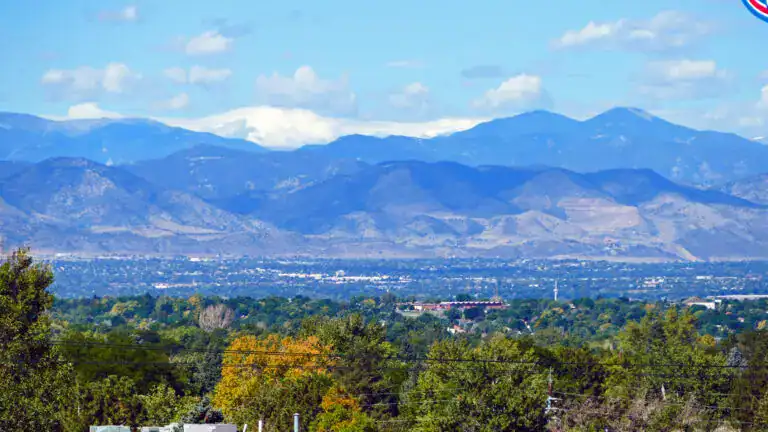 View of Wheat Ridge, Colorado neighborhoods with Front Range mountain scenery representing roof replacement, siding replacement, and window replacement services provided by Road Home Exteriors.