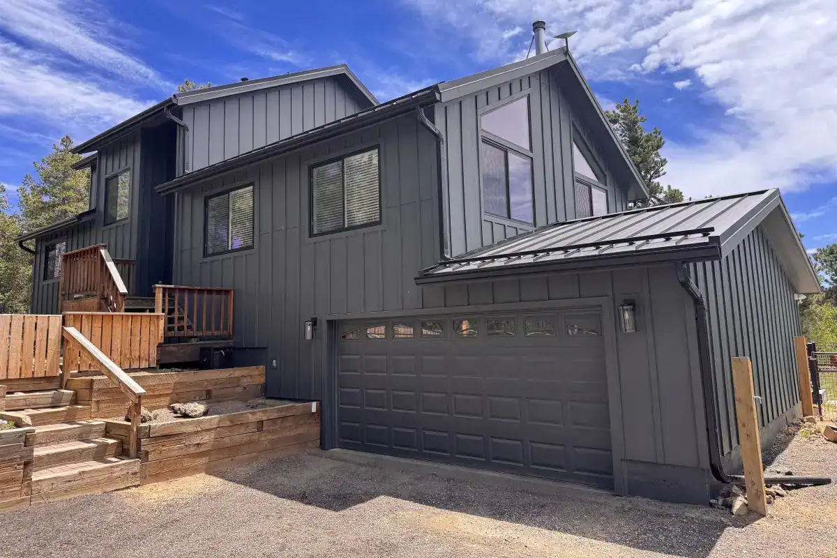 Black Pella Impervia fiberglass windows installed by Road Home Exteriors on a mountain home in Nederland, Colorado.