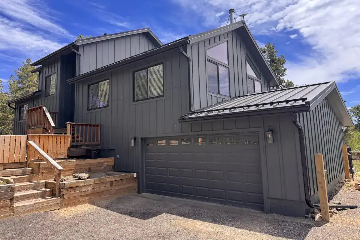 Black Pella Impervia fiberglass replacement windows installed by Road Home Exteriors on a home in Nederland, Colorado for lasting durability, energy efficiency, and modern curb appeal.