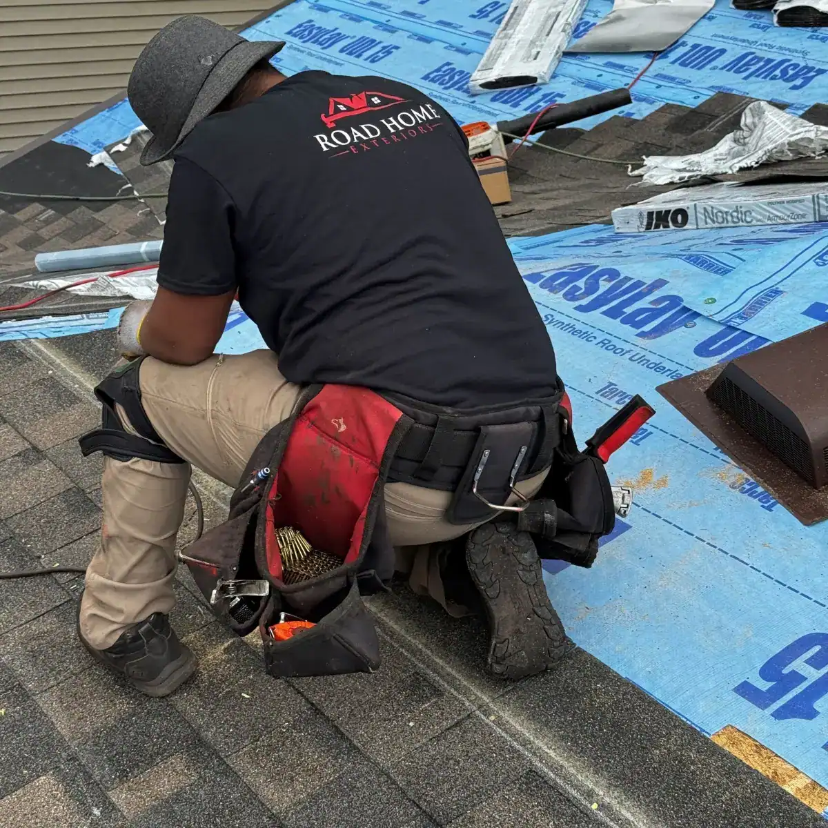 Road Home Exteriors installer installing an IKO architectural shingle roof on a home in Aurora, Colorado using premium synthetic underlayment.