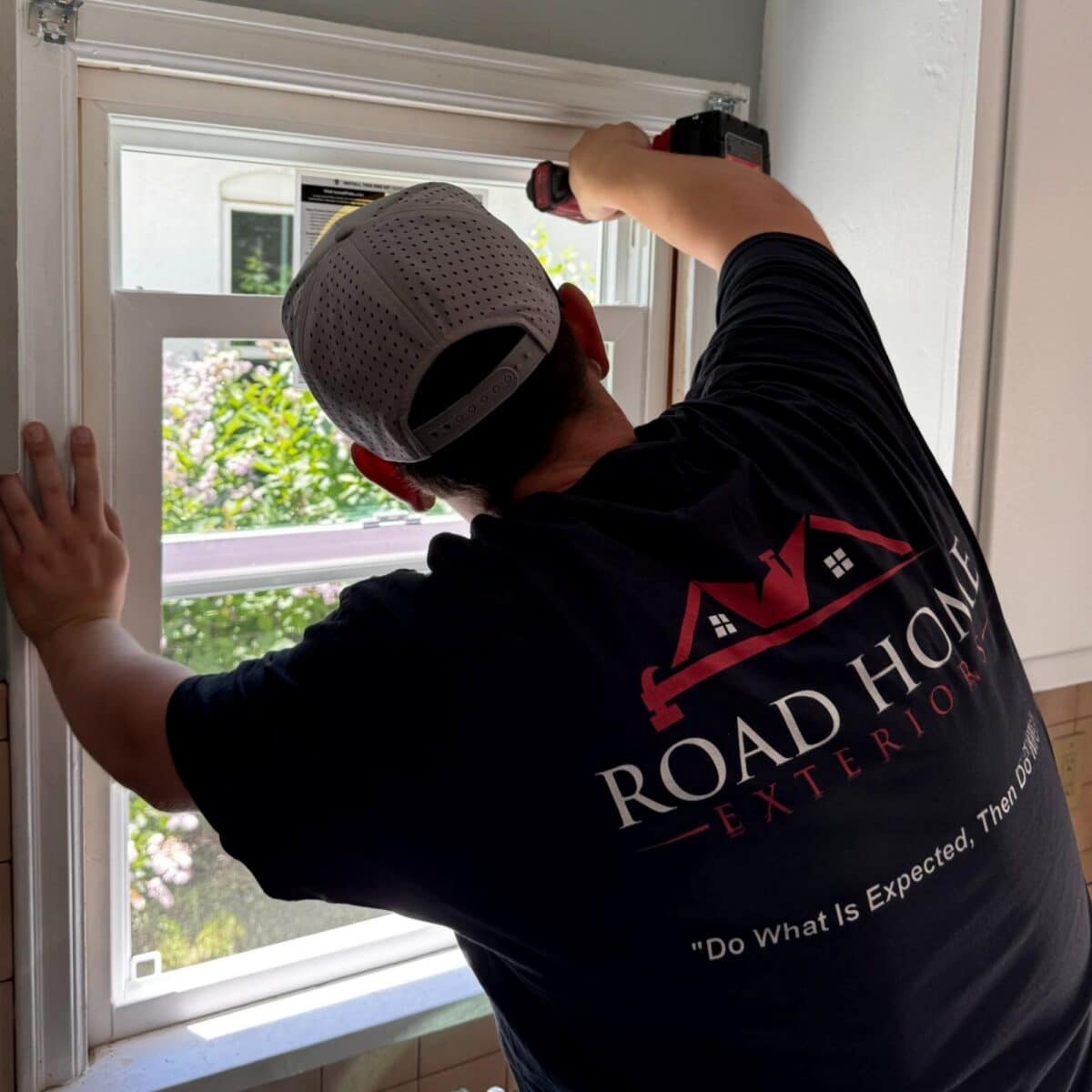 Road Home Exteriors installer securing a Pella replacement window during a window installation project in Denver, Colorado.