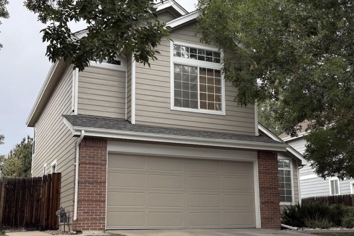 Westminster home with Diamond Kote Oyster Shell lap siding, soffit, fascia, and trim installed by Road Home Exteriors