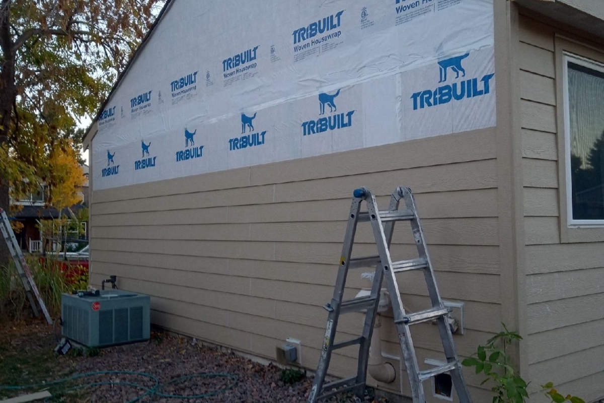 LP SmartSide lap siding repair in progress with exposed housewrap on a home in The Highlands neighborhood of Centennial