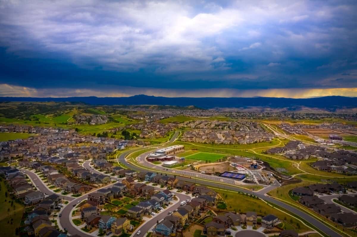 Aerial view of South Metro neighborhoods beneath storm clouds along the Colorado Front Range