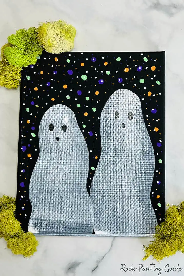 Easy Ghost Craft: Halloween Squeegee Painting for Kids 8 ghost painting with green moss around the canvas