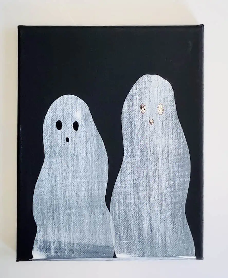 Easy Ghost Craft: Halloween Squeegee Painting for Kids 7 ghost craft painting: Adding black faces to dried white painted ghosts with a paint marker